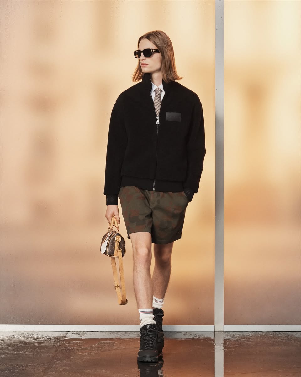 Louis Vuitton SS2027 Men's Pre-Collection black bomber jacket with camo shorts and monogram handbag