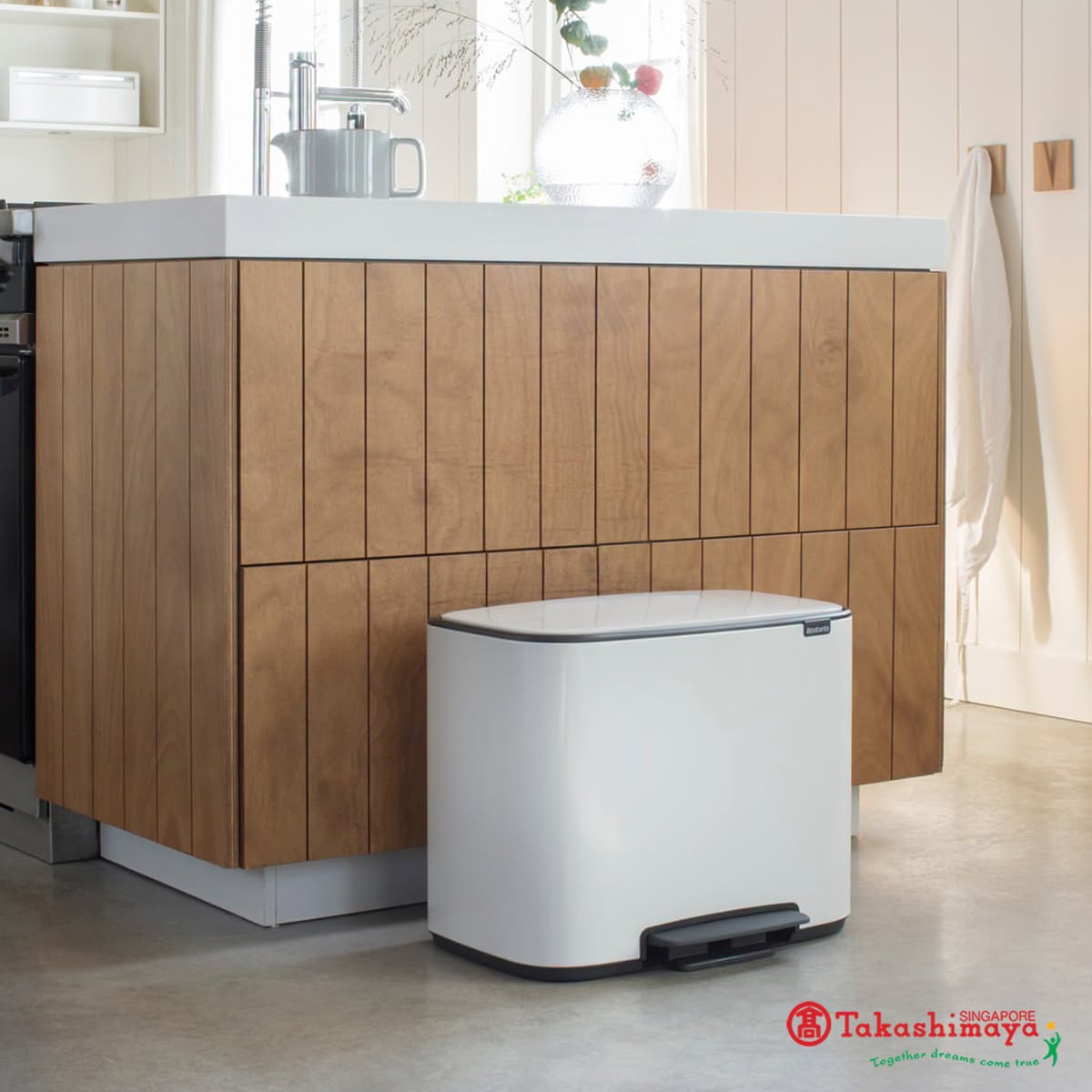 White pedal bin displayed in kitchen setting at Takashimaya
