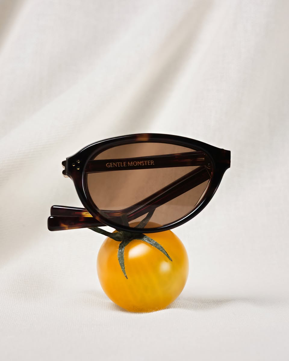 Gentle Monster tortoiseshell sunglasses on a cherry tomato