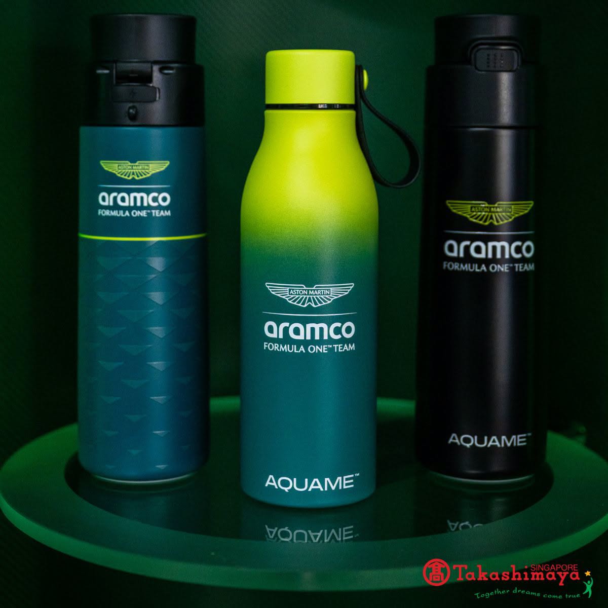 Three AQUAME water bottles with Aramco Formula One Team branding