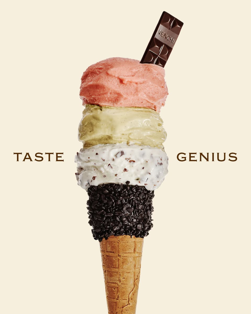 Venchi gelato cone with four scoops topped with a Venchi chocolate bar