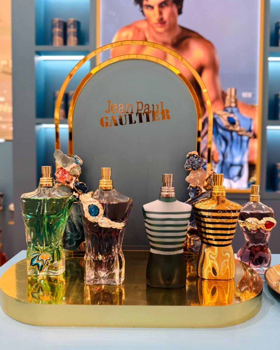 Jean Paul Gaultier perfume bottle collection on gold tray