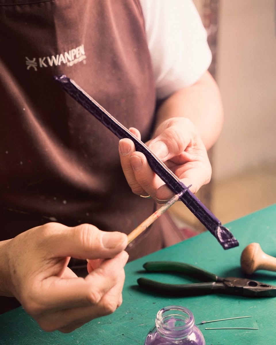KWANPEN craftsman applying varnish to wooden object