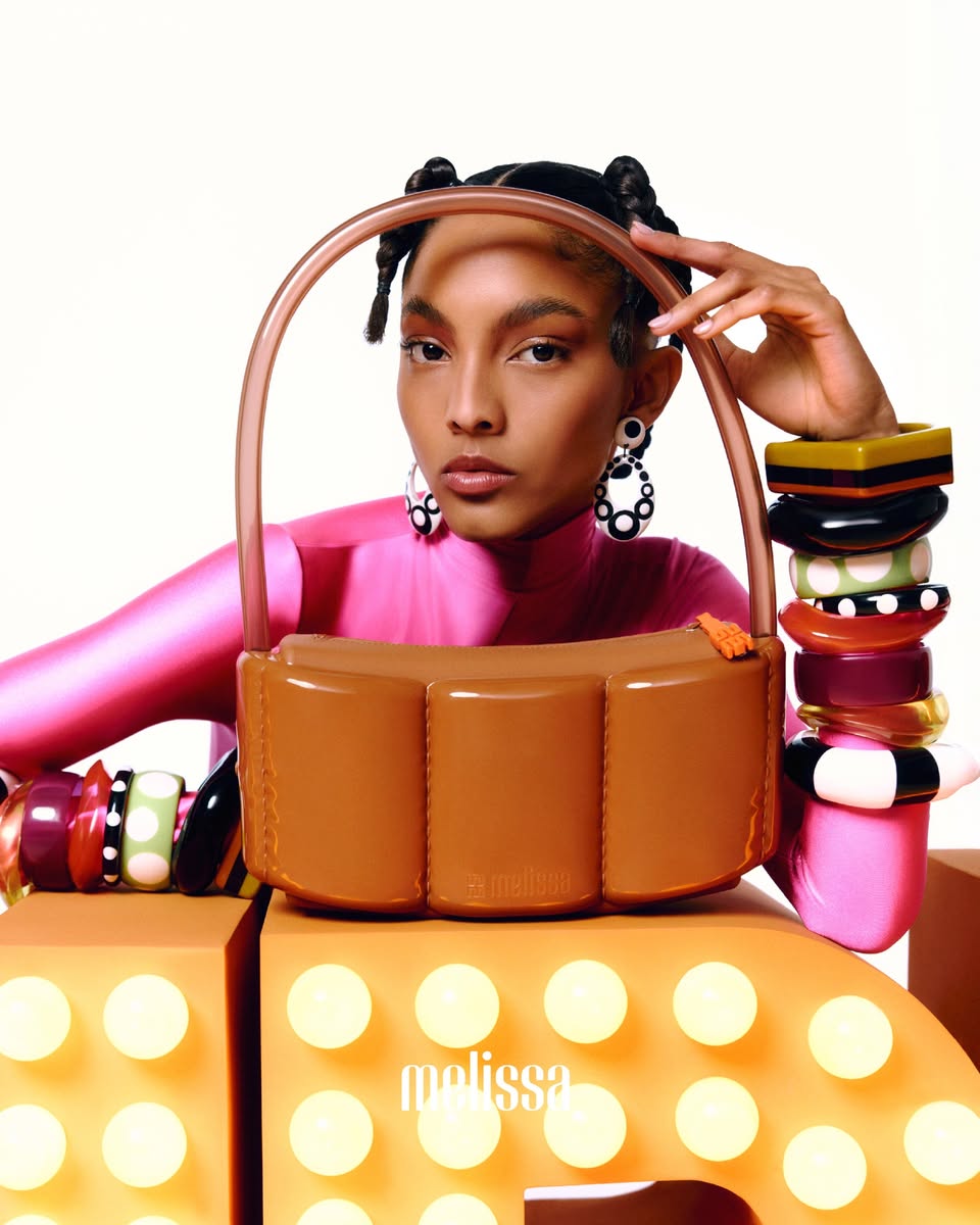 Melissa branded handbag with segmented body and arched handle