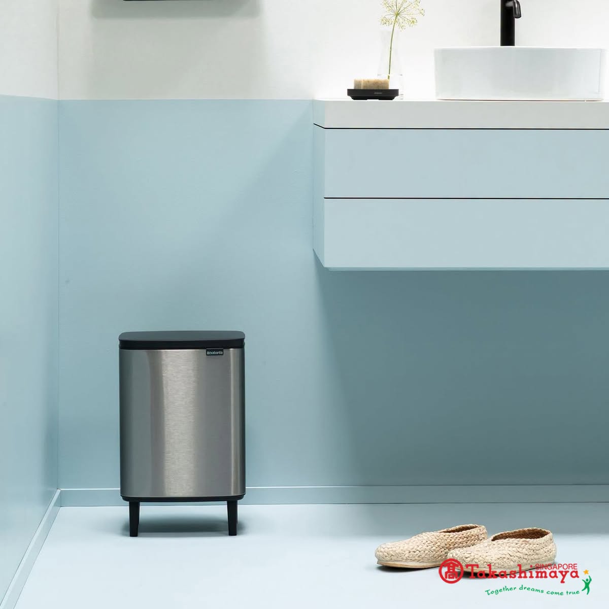 Stainless steel trash bin and bathroom accessories at Takashimaya