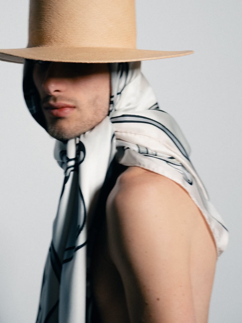 Patterned scarf with straw hat styling