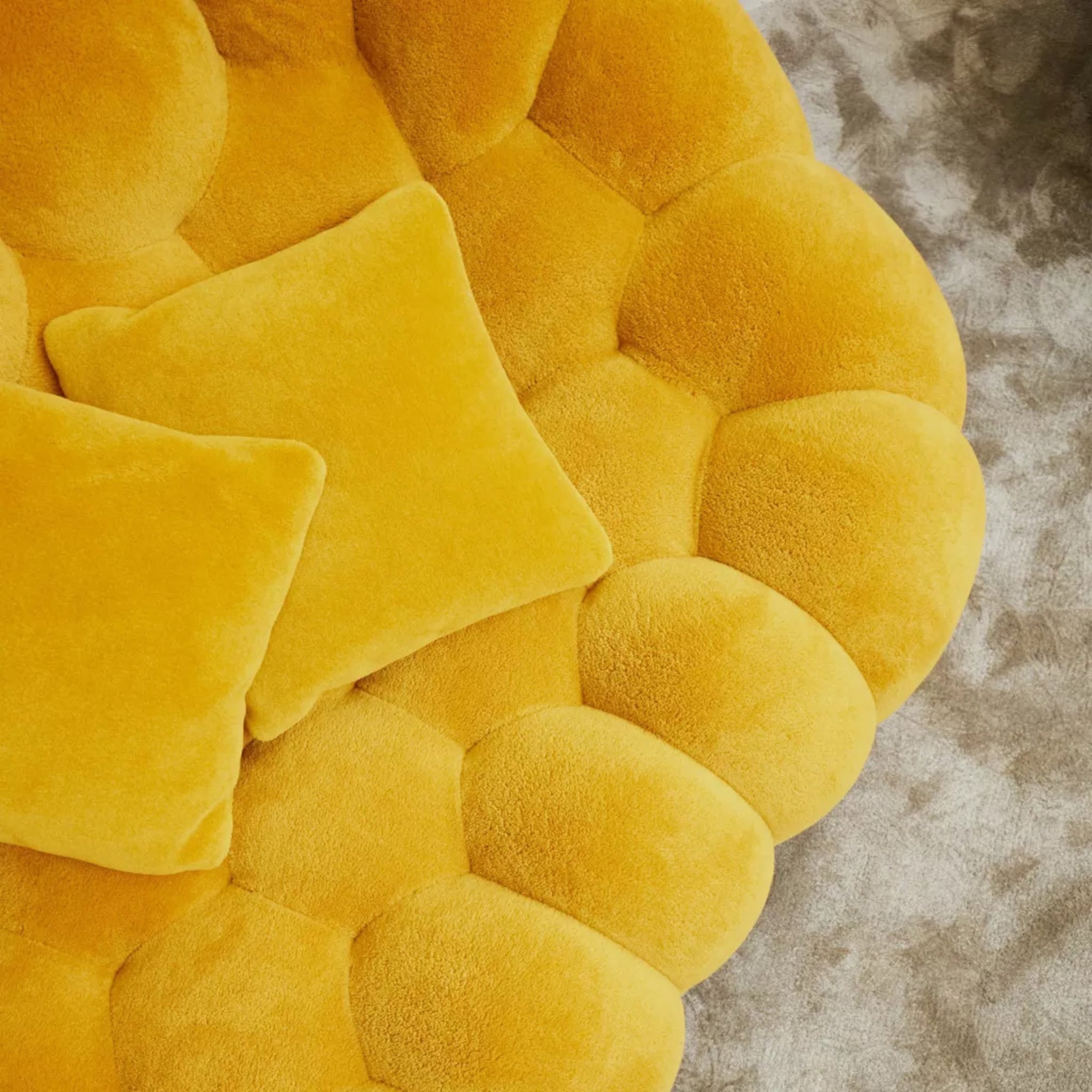 Yellow plush sofa with scalloped edge design