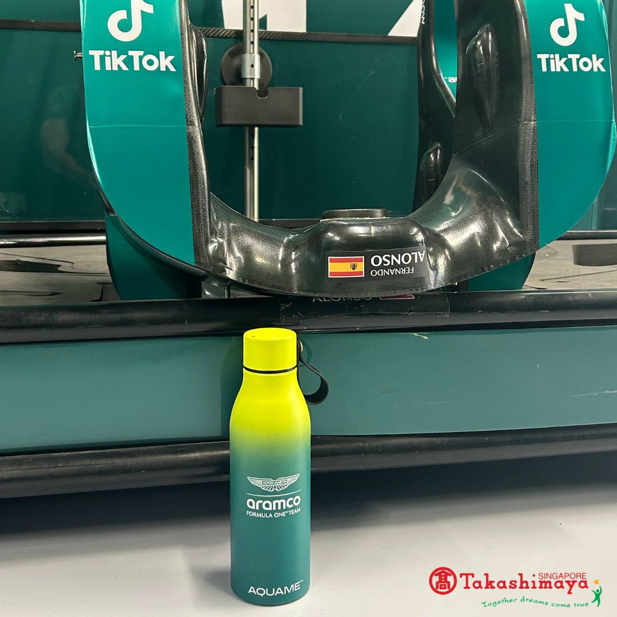 Aquame bottle displayed in front of F1 car at Takashimaya