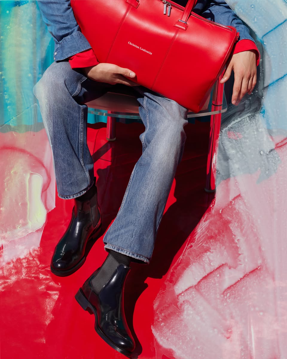 Christian Louboutin red leather tote bag and black Chelsea boots from the Winter 2026 collection