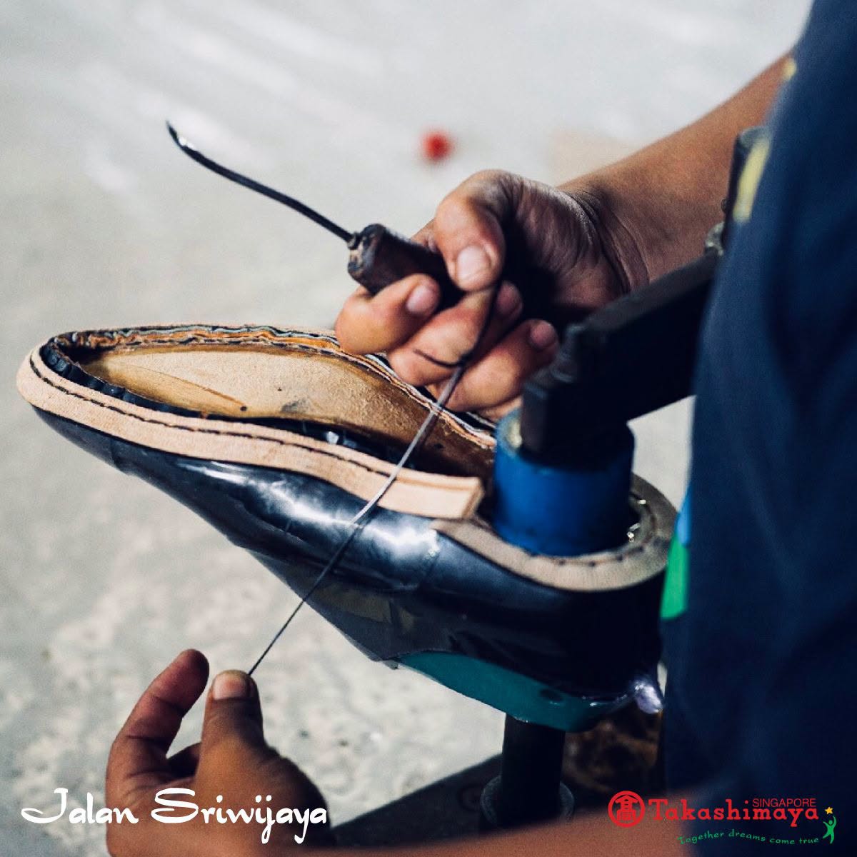 Cobbler hand-stitching a shoe sole using traditional leatherwork tools at Takashimaya Singapore