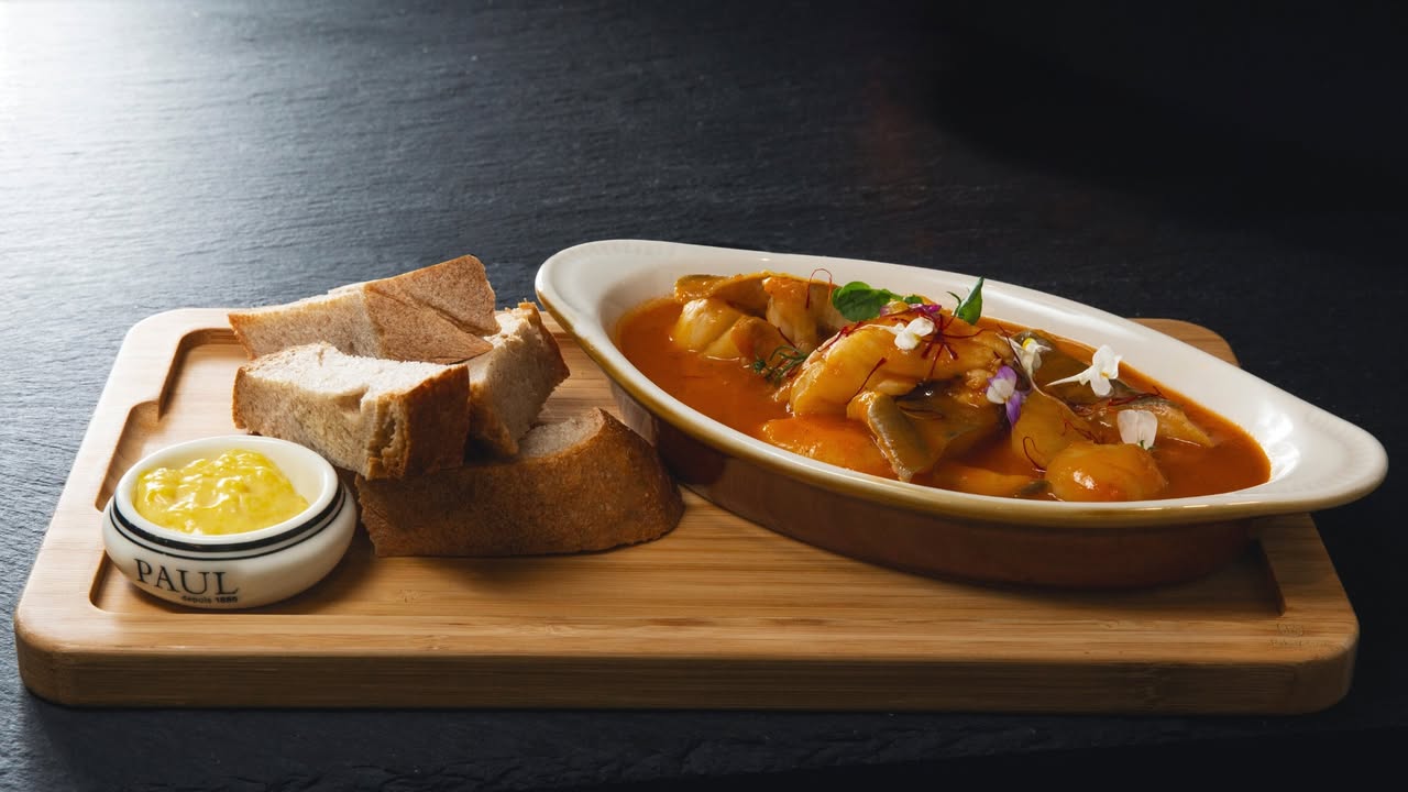 Fish curry dish served with bread at Maison Paul