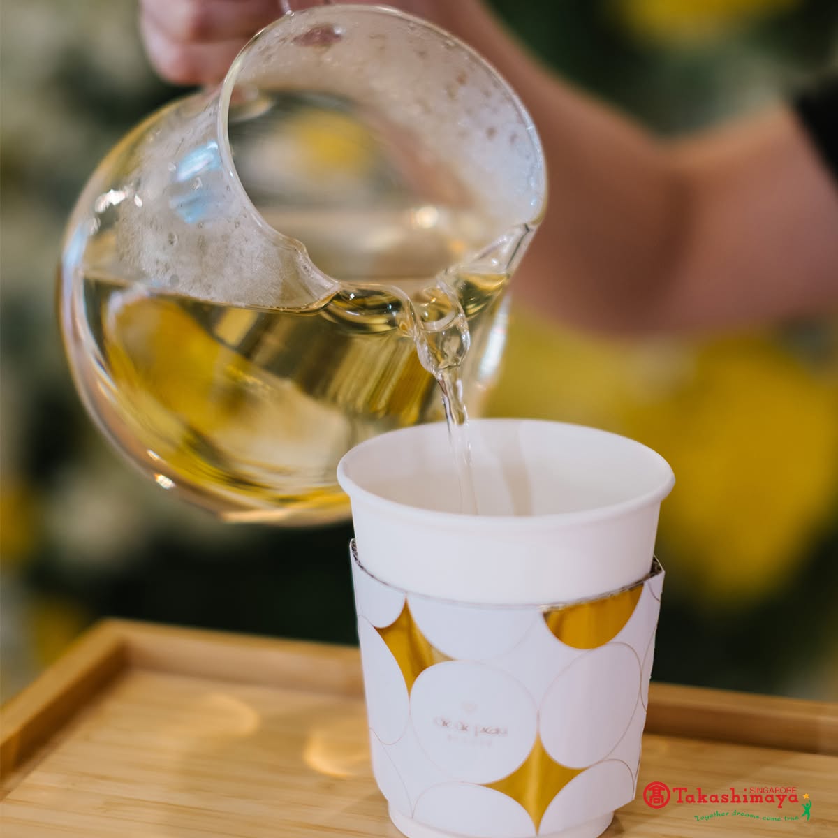 Takashimaya branded tea cup being filled at the event