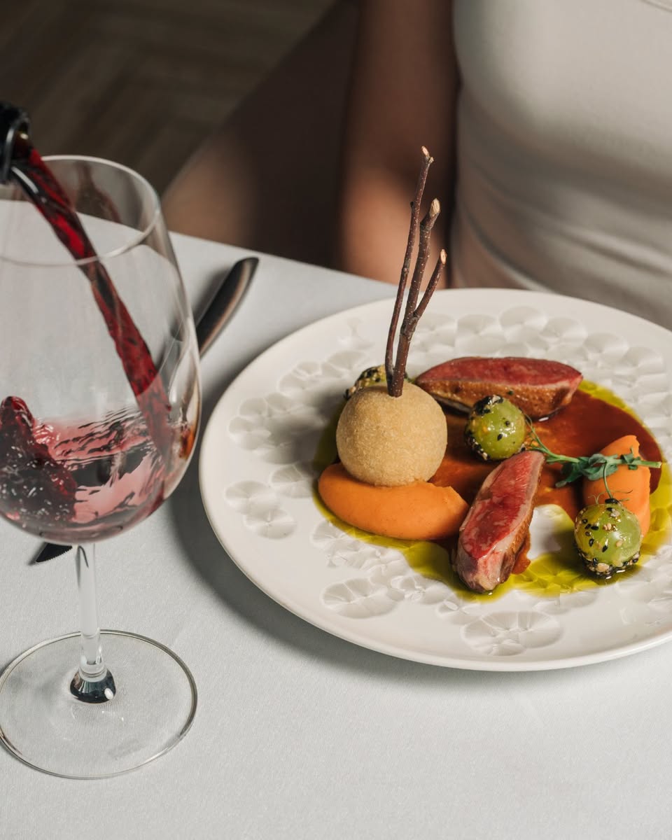 Plated meal with red wine at 1-Atico