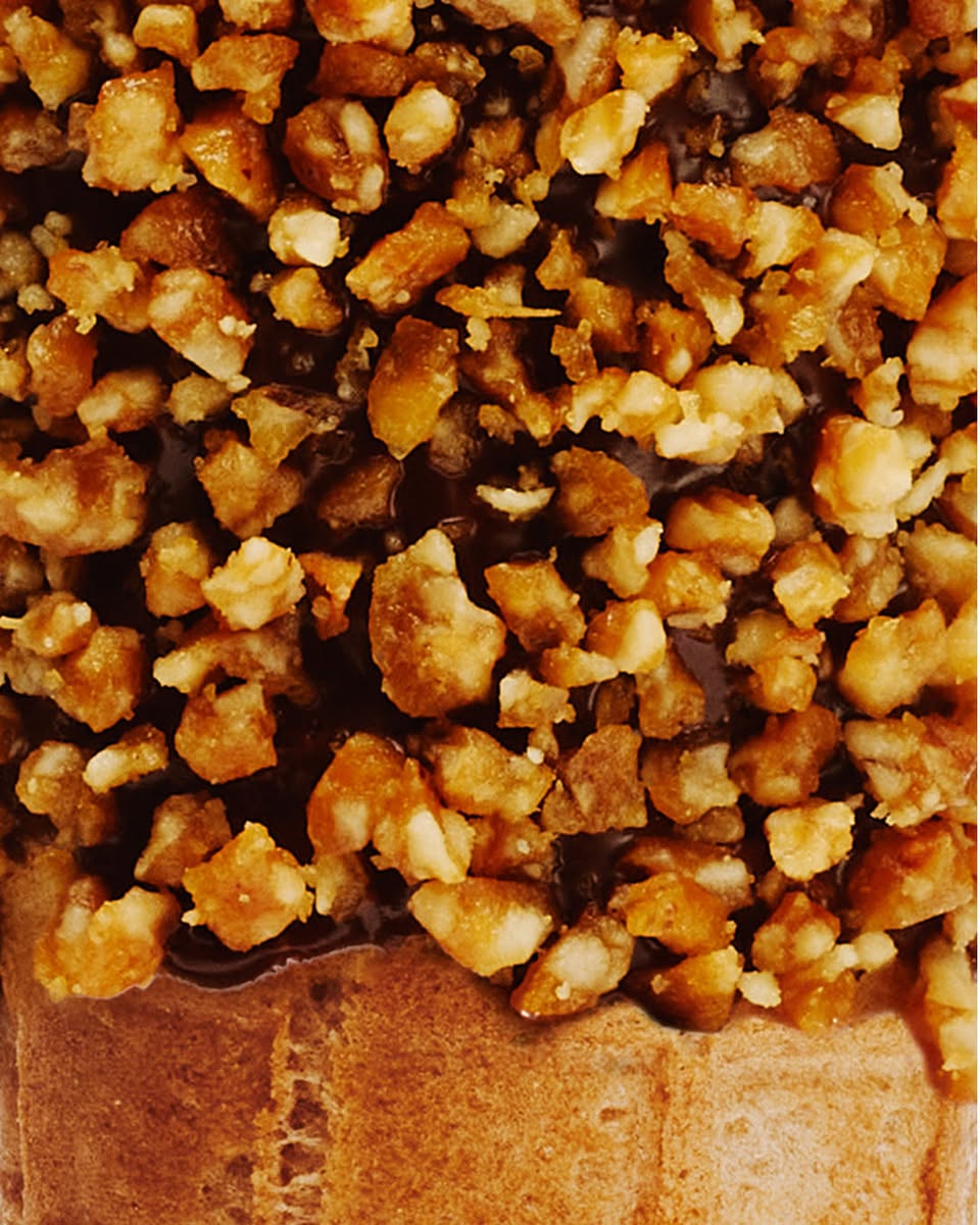 Venchi dessert topped with nuts and chocolate drizzle