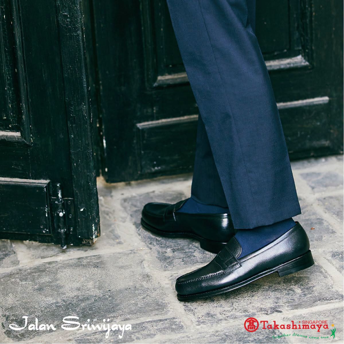 Black leather loafers styled with navy socks at Takashimaya Singapore