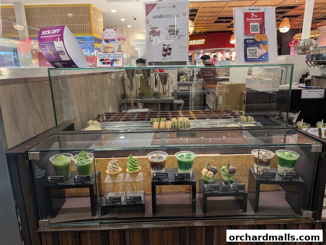 A display case filled with various matcha-flavored desserts and drinks at 108 Matcha Saro.