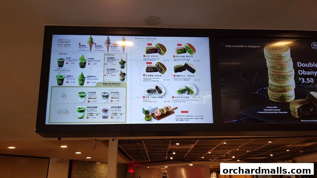 A digital menu board displaying various matcha-flavored drinks, parfaits, and desserts.