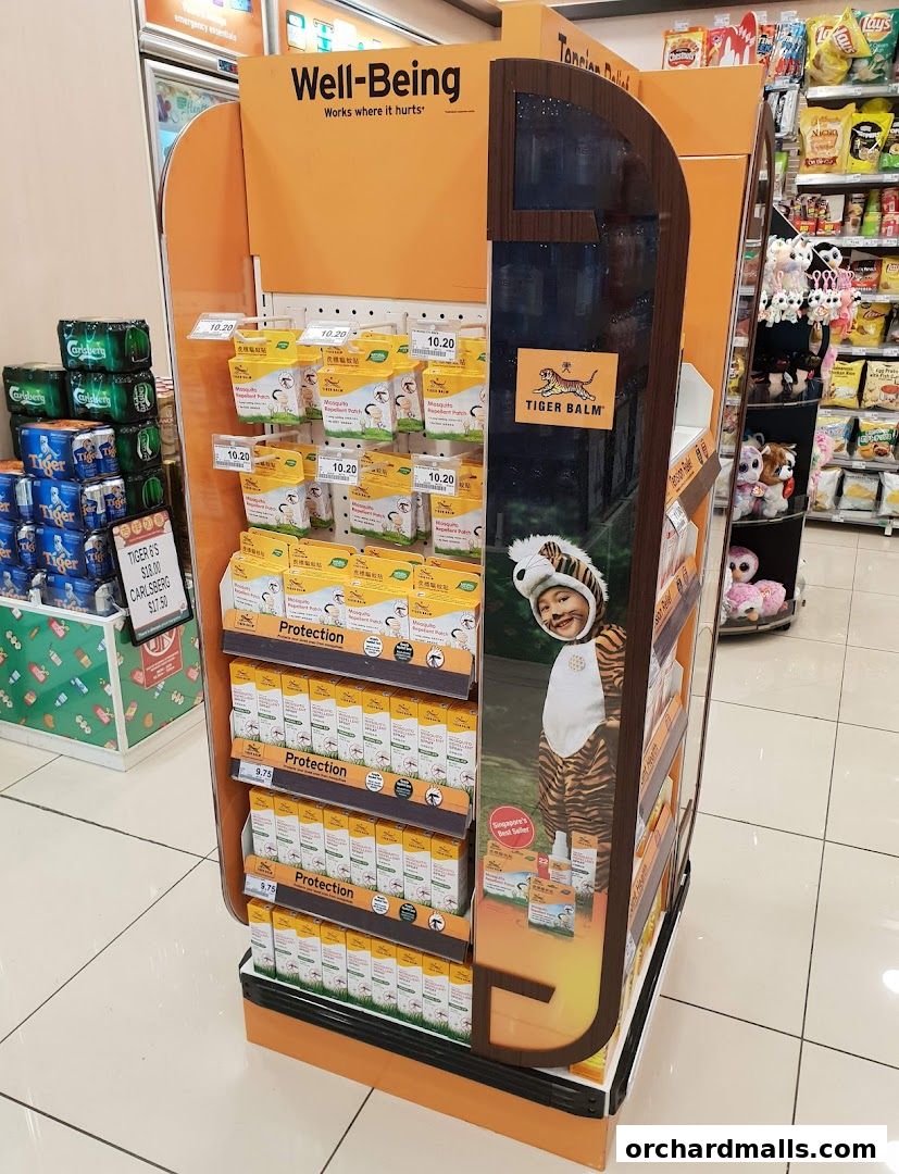 A display stand featuring Tiger Balm products and other convenience items in a 7-Eleven store.