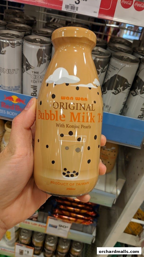 A hand holds a bottle of Wan Wan Original Bubble Milk Tea with Konjac Pearls.