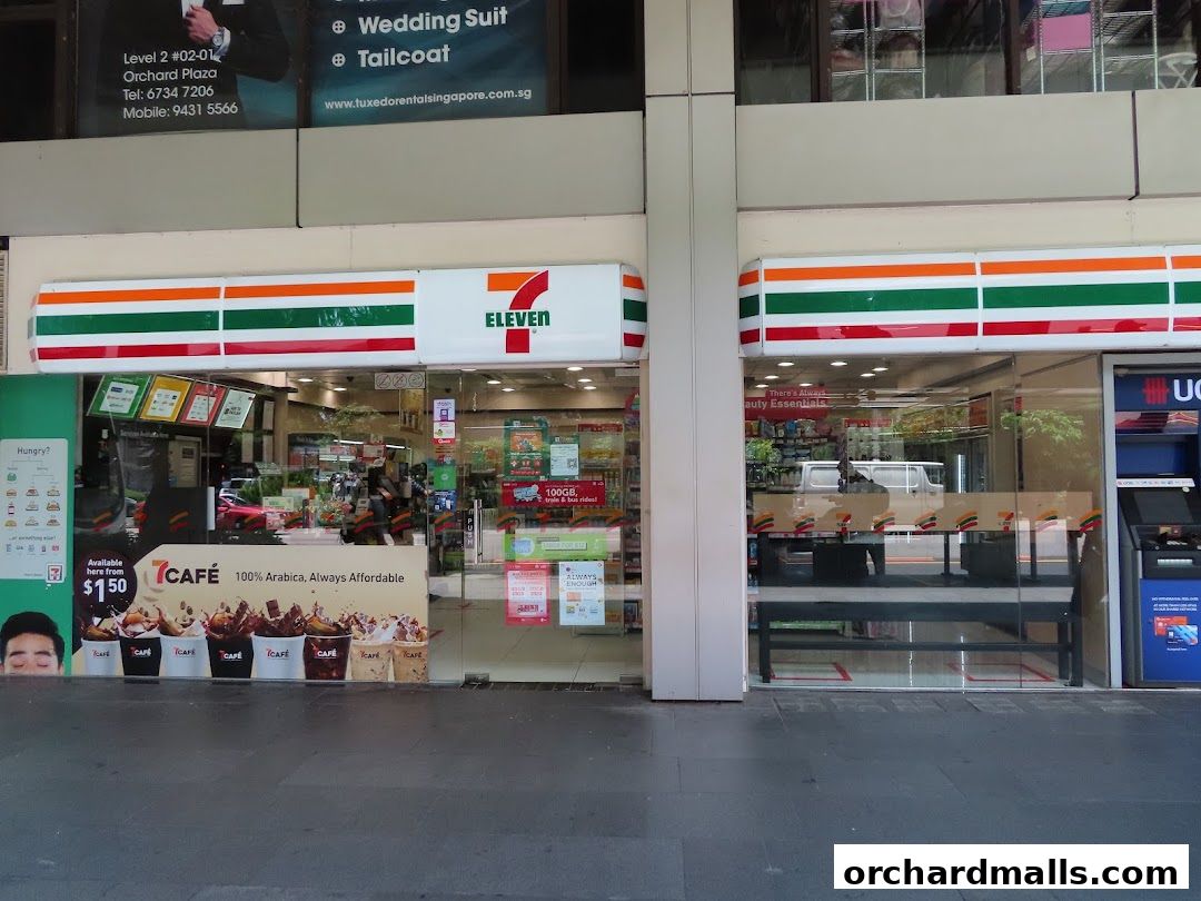 The exterior of a 7-Eleven convenience store with its prominent branding and display windows.