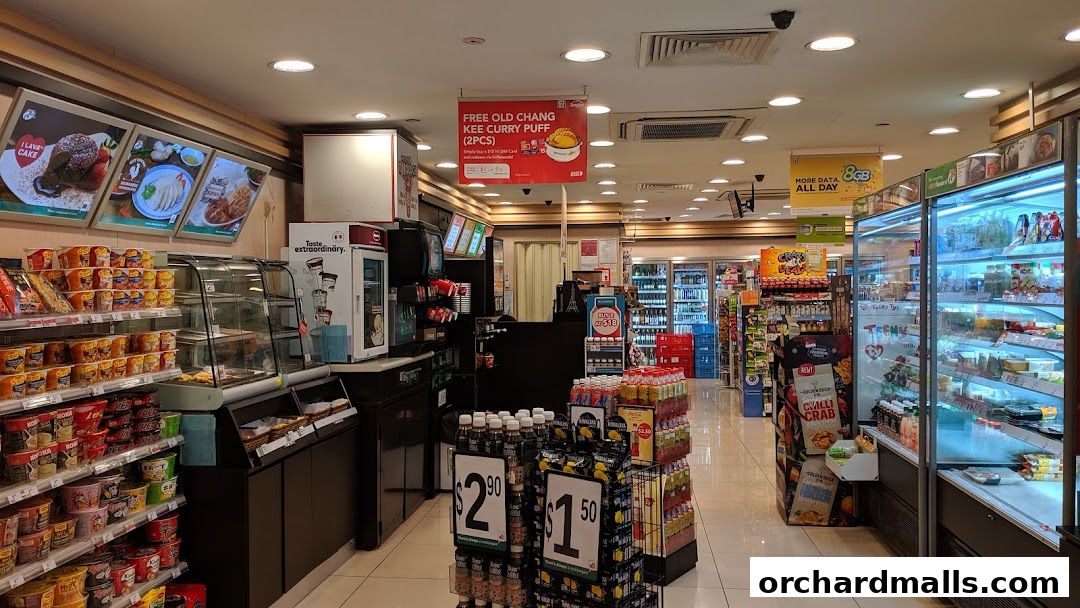 Interior view of a 7-Eleven convenience store with shelves stocked with food and drinks.