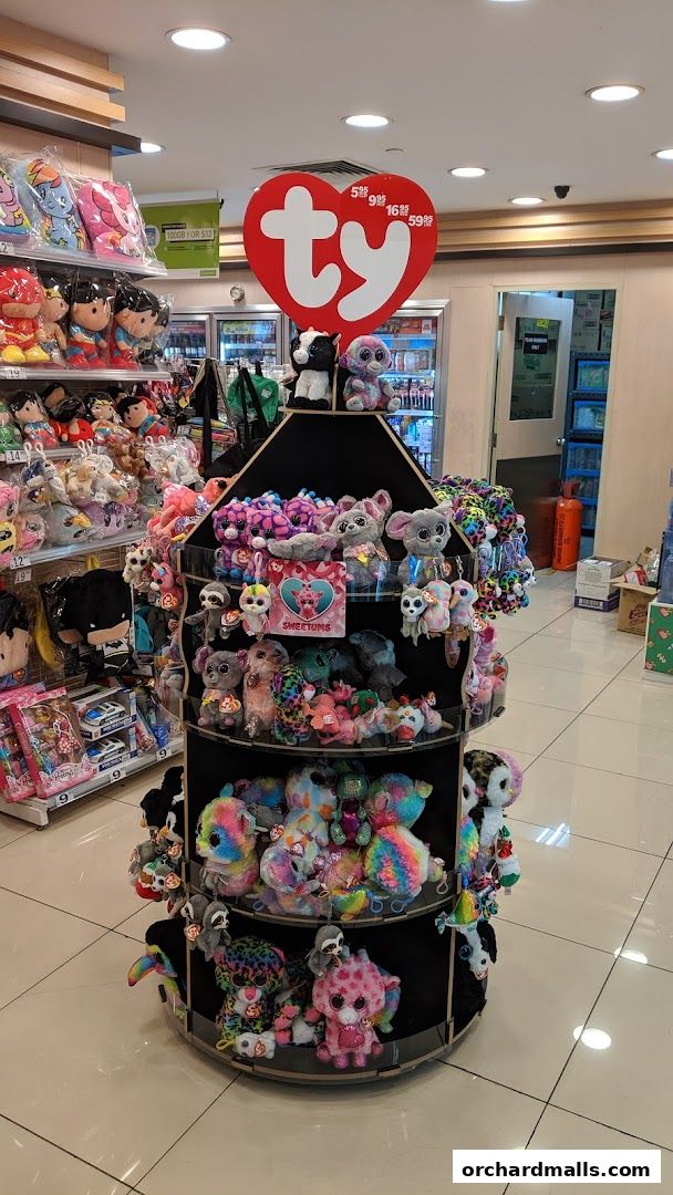 A display of colorful plush toys, including Ty Beanie Boos, in a retail store.