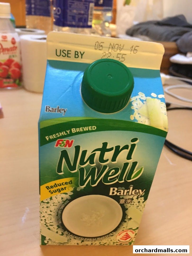 A carton of NutriWell Barley drink with reduced sugar and no added preservatives.