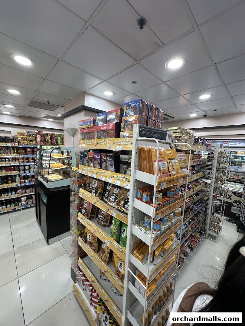 Interior view of a 7-Eleven convenience store with shelves stocked with snacks and drinks.