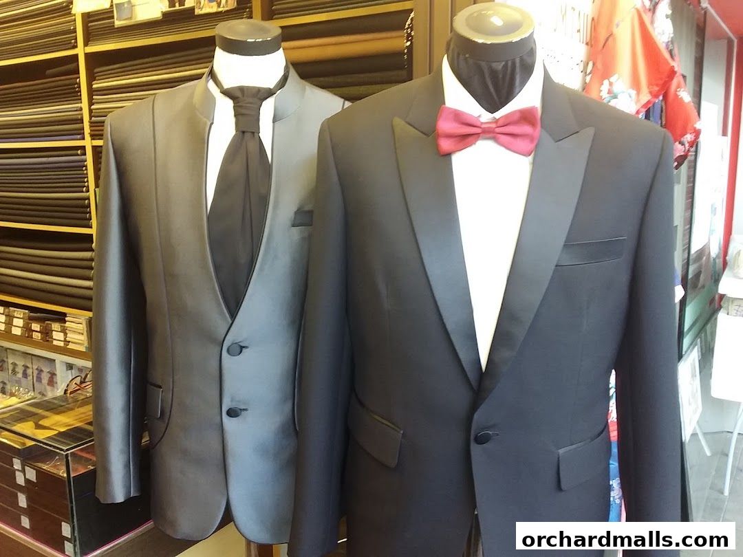 Mannequins display tailored suits and fabrics in a tailor shop.
