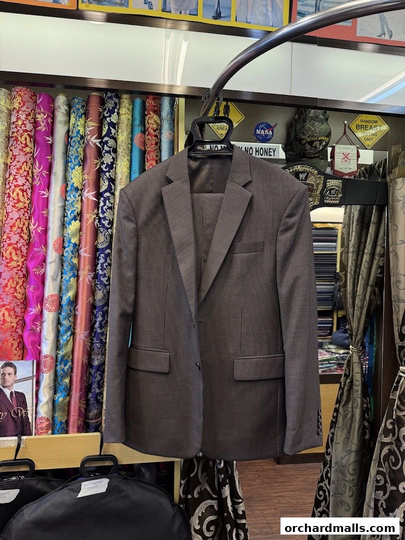 A tailor shop displays a suit, colorful fabrics, and various decorative items.