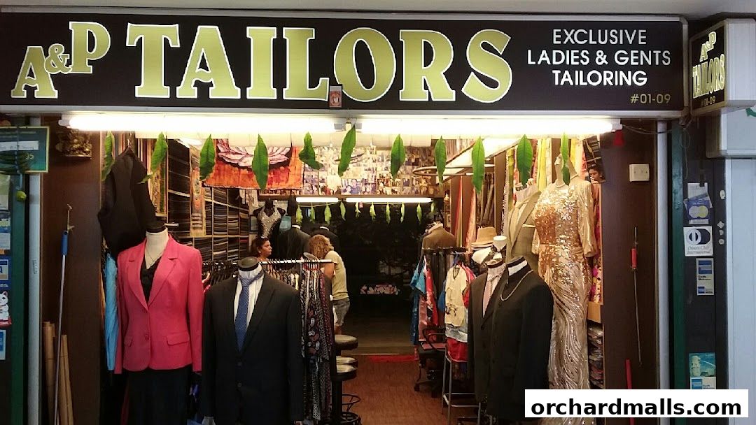 A tailor shop entrance displaying mannequins with suits and dresses, and fabric rolls.