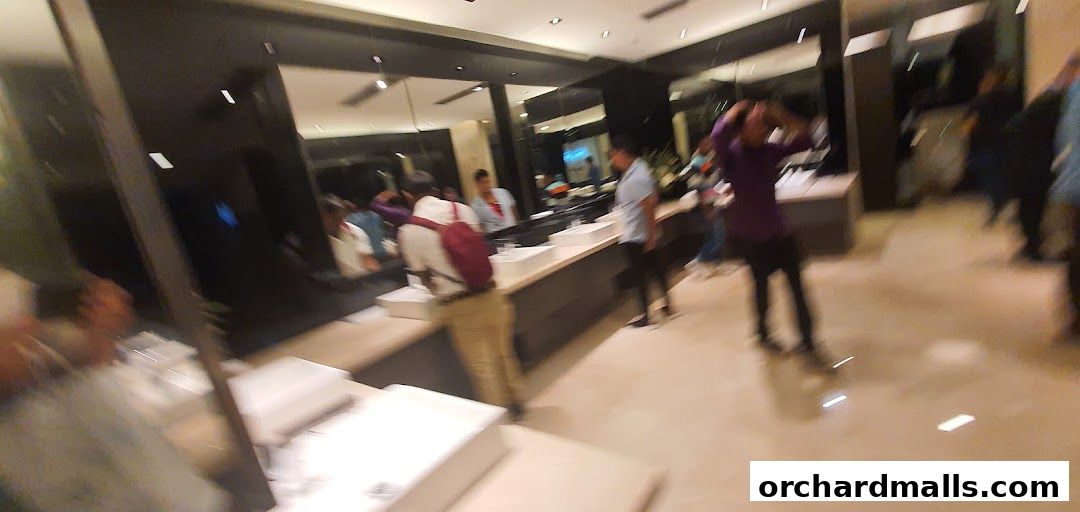 People browsing in a modern retail store with sleek displays and mirrors.