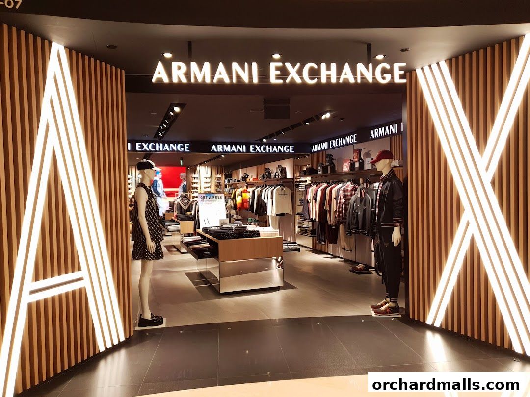 The entrance to an Armani Exchange store featuring mannequins and displayed clothing.