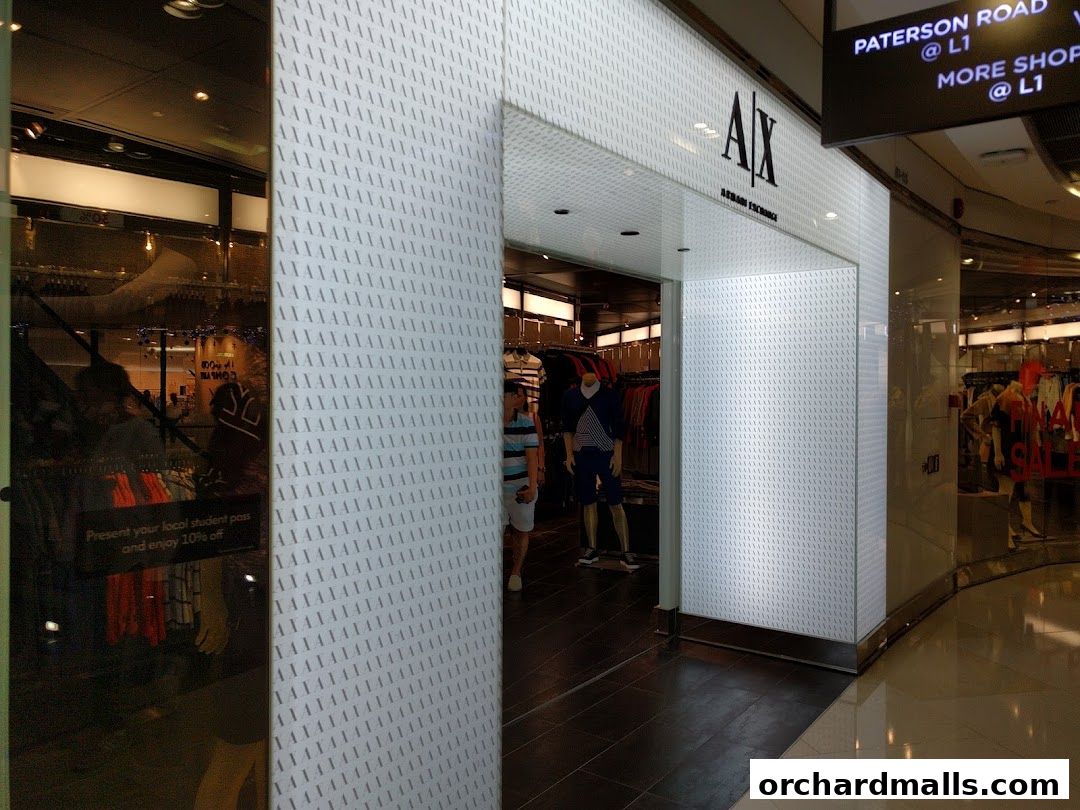 The entrance to an AX Armani Exchange store with mannequins and clothing displays visible inside.