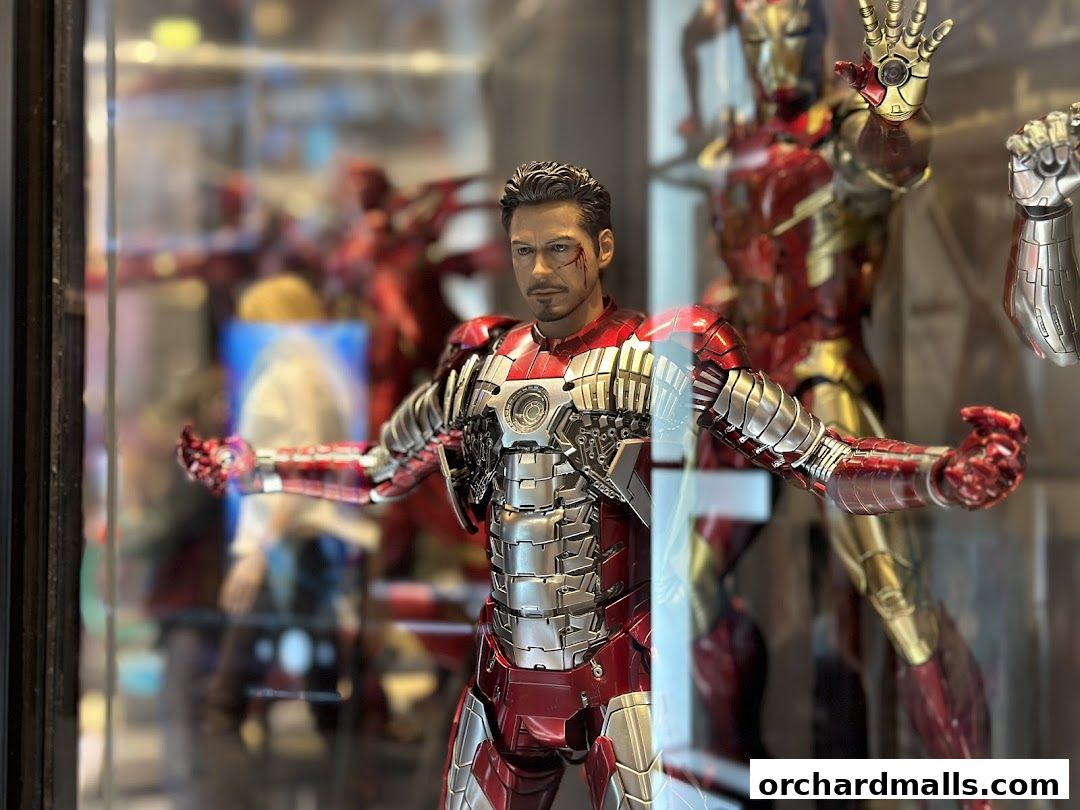 Detailed Iron Man action figures displayed in a shop window.