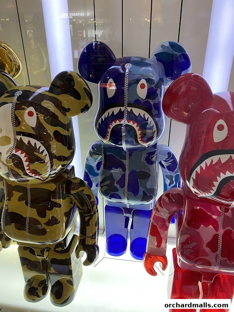 Three colorful designer bear figurines with camouflage patterns and shark teeth designs.