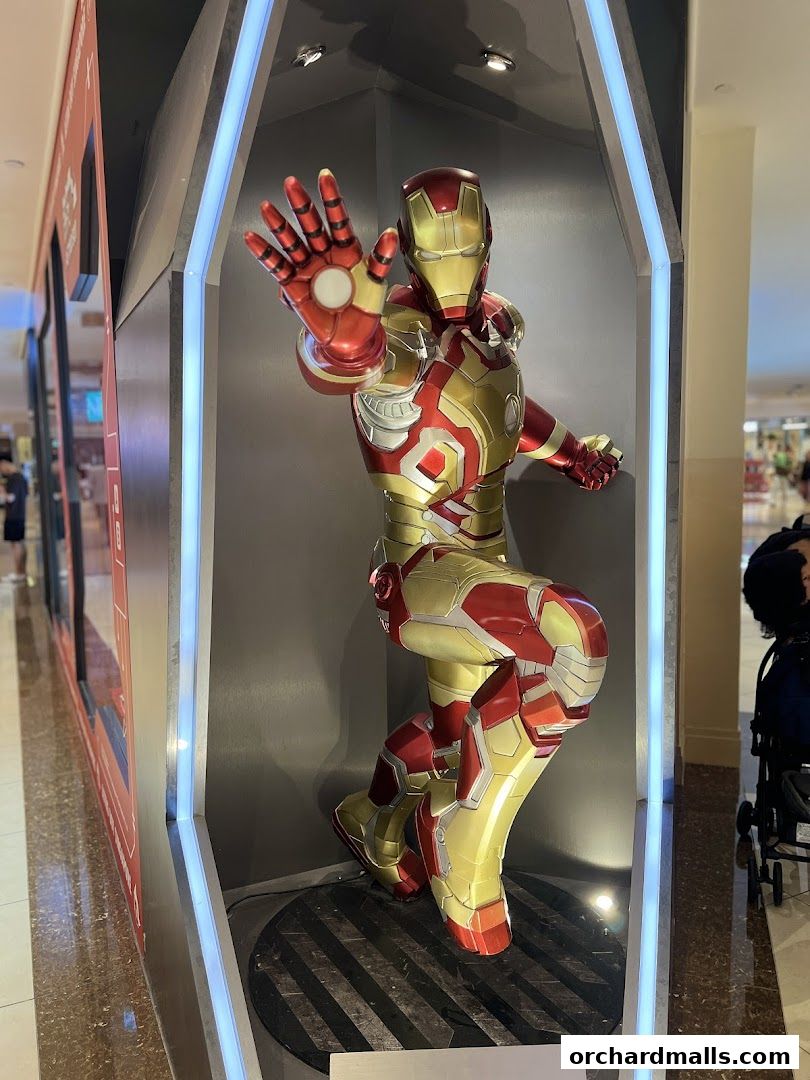 An Iron Man statue is displayed in a brightly lit showcase at ActionCity.
