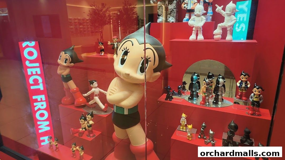A shop window display featuring various Astro Boy figurines and merchandise in red and white.