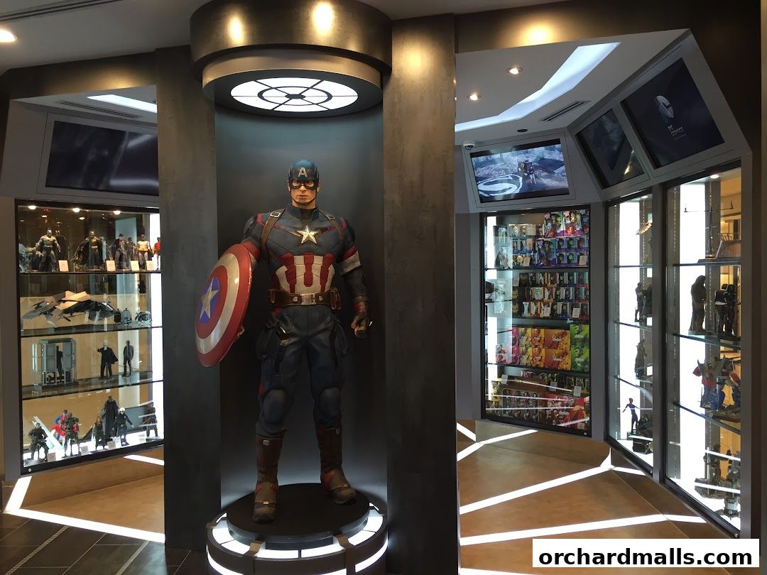 A life-sized Captain America statue stands in a store filled with collectible figures and merchandise.