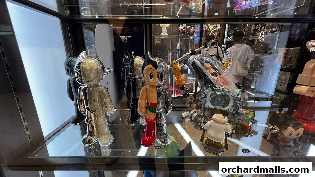 Display case filled with collectible designer toys and figures, including Astro Boy.