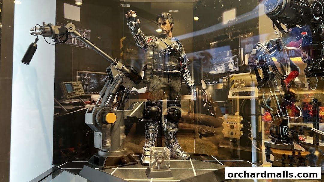 A detailed action figure of Iron Man in a workshop setting with robotic arms.