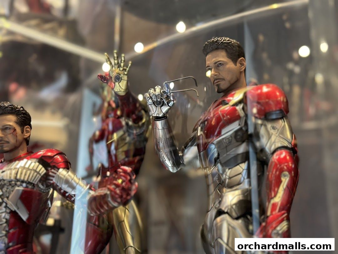 Detailed action figures of Iron Man in a display case at ActionCity.