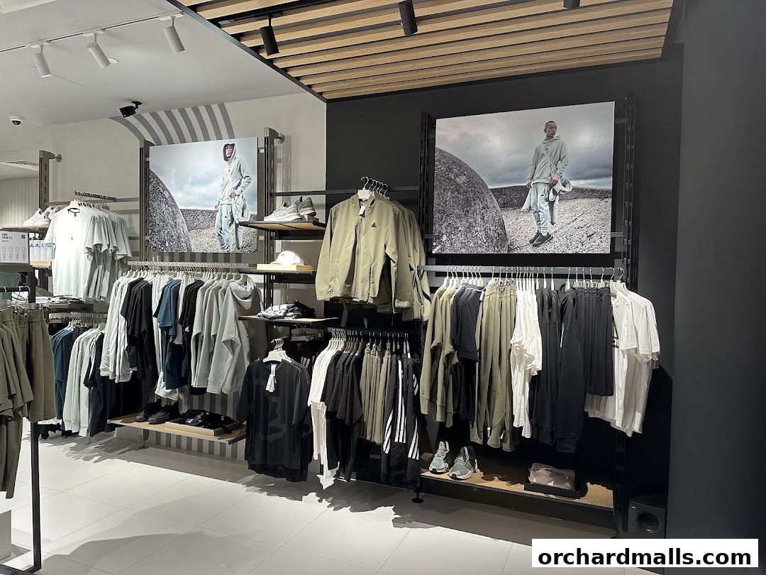 Interior view of an Adidas Performance Store showcasing apparel and footwear on display racks.