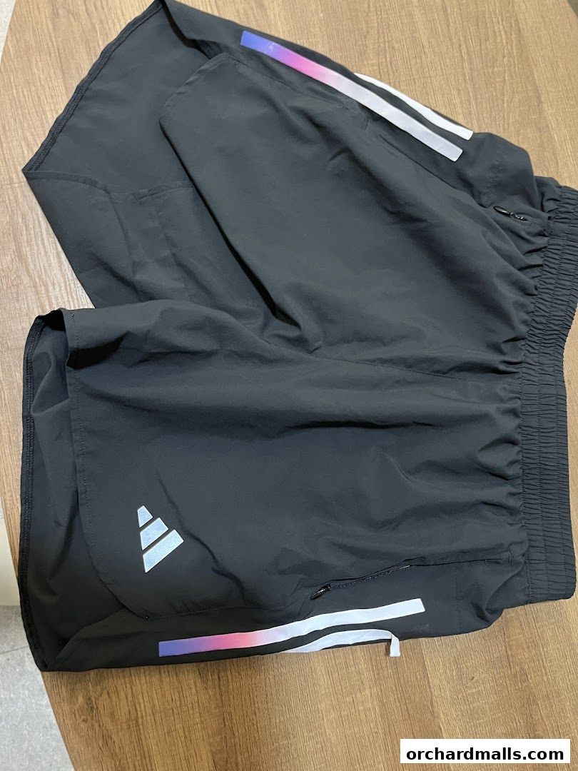 Black Adidas running shorts with reflective stripes and logo.