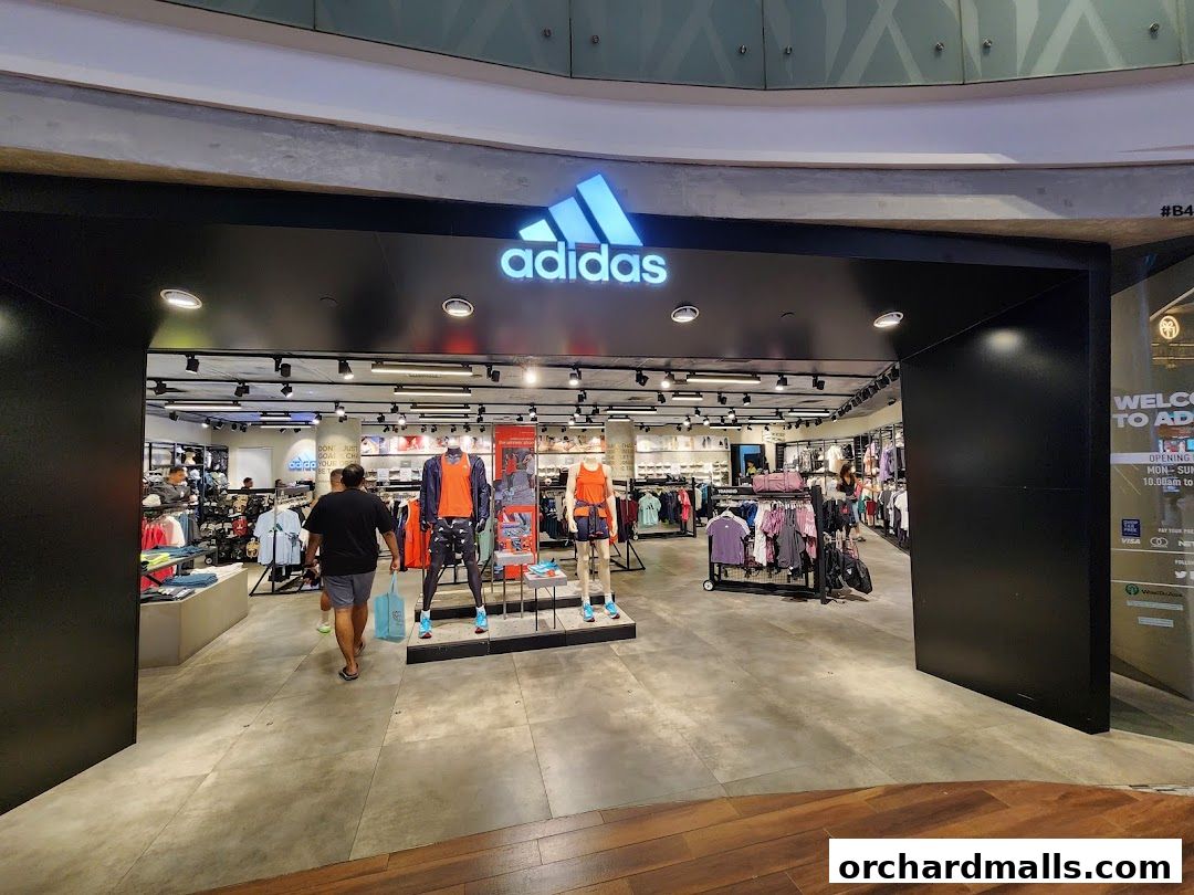 The entrance to an Adidas Performance Store, showcasing athletic apparel and footwear on display.