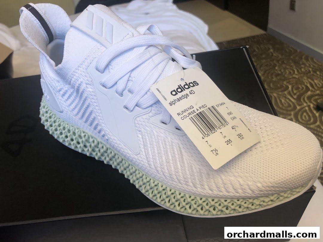 A close-up shot of a white Adidas running shoe with a distinctive 3D printed sole.