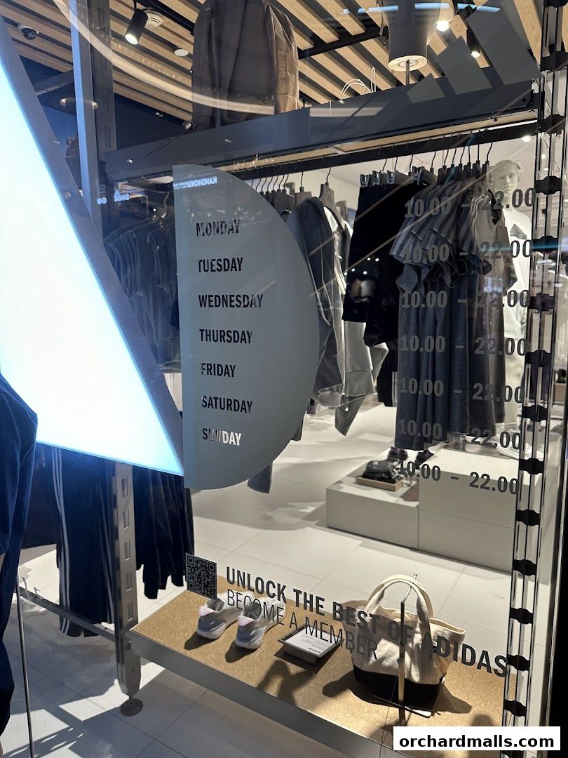 Shop window display featuring Adidas apparel, footwear, and a membership promotion.