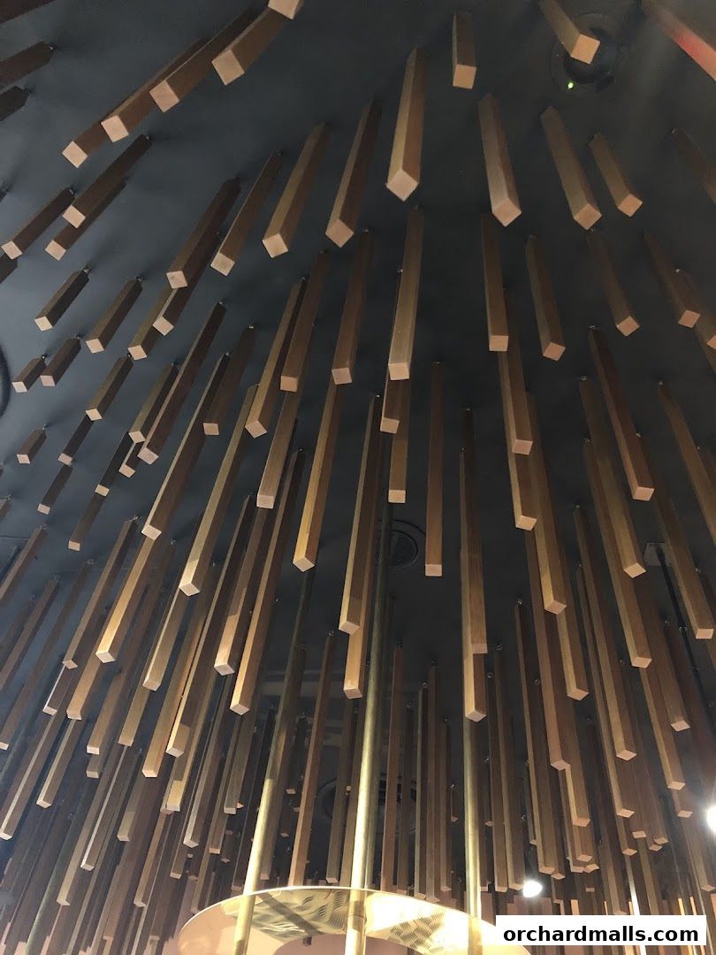 A ceiling adorned with numerous wooden slats and metallic rods, creating a unique architectural feature.