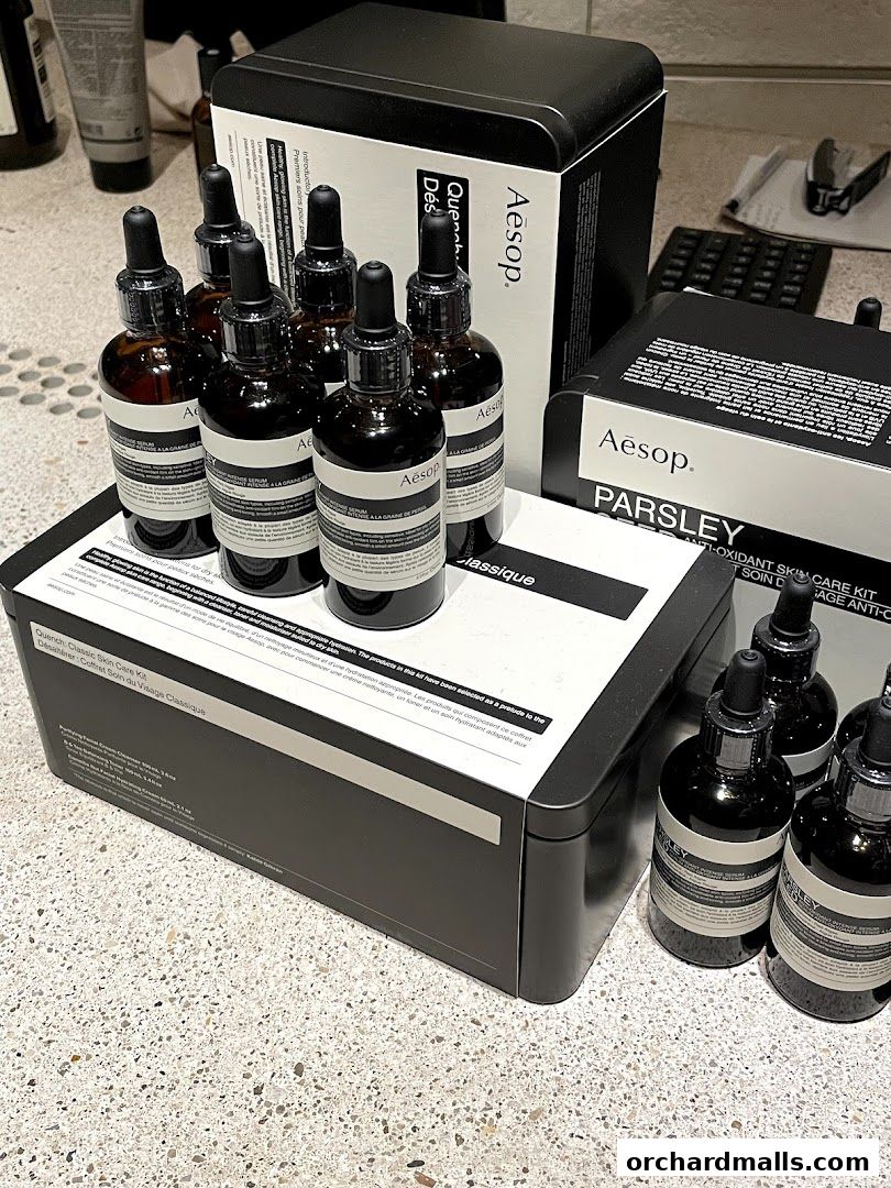 Aesop skincare products, including serums and a skin care kit, displayed in minimalist packaging.