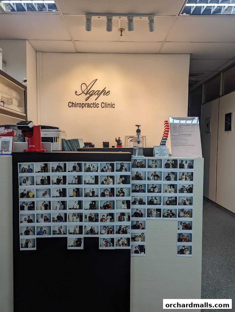 The reception area of Agape Chiropractic Clinic with photos displayed on the wall.